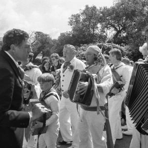 Master of ceremonies of the Old Oss leading accordion players