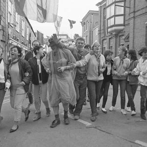 People walking down the street arm in arm