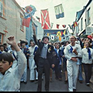 Blue Ribbon Oss Master of Ceremonies leading procession down street