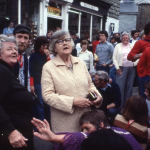 People standing and squatting in the street