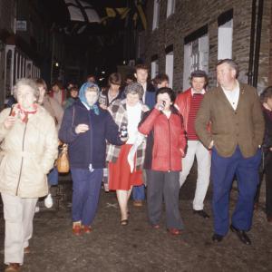People walking through town at night