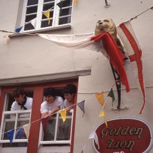 People watching from Golden Lion upstairs window