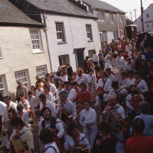 Old Oss procession walking along road