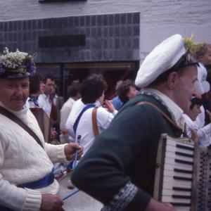 Men playing accordions and drums in procession