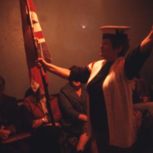 Woman singing, holding union flag 