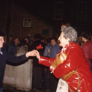 Women holding poppy flower