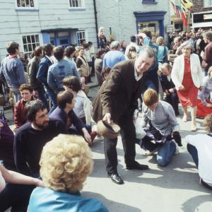 People sitting under maypole