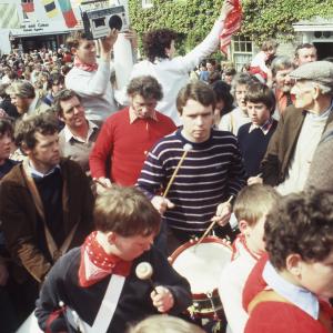 Musicians playing outside, man with boom box behind