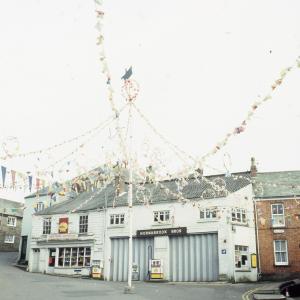 Maypole under cloudy sky, deserted Broad Street