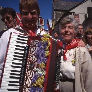 Man from Old Oss with accordion, with his arm around woman