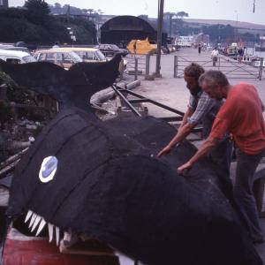Men deconstructing carnival whale
