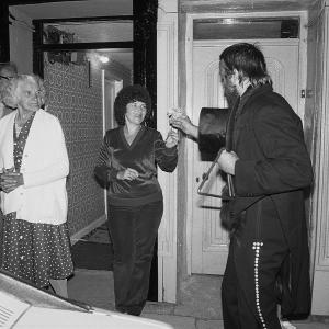 Merrymakers at night interacting with locals