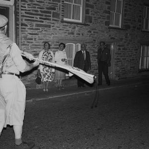 Merrymakers at night, locals watch