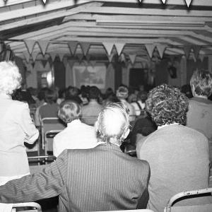 People watching slide show presenting Doc Rowe's photos