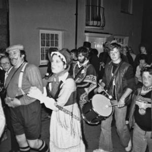 Musicians in parade on street at night