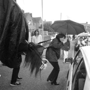 Old Oss woman in rain