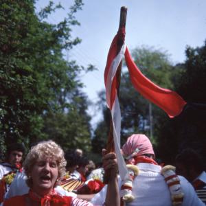 Woman holding Old Oss flag