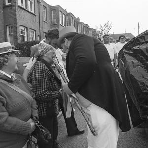 master of ceremonies speaking to old woman