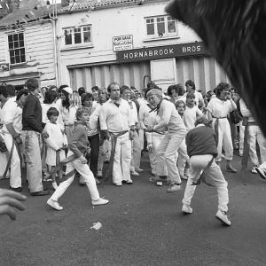 boys dancing under maypole