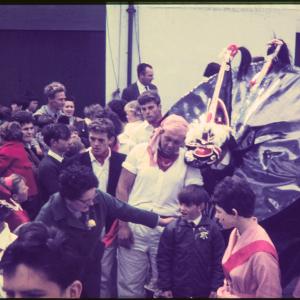 Old Oss with child, man and surrounded by crowd