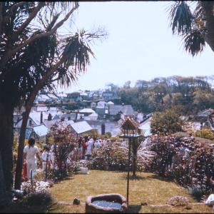 Old Oss procession walking through garden