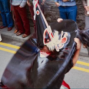 Child putting on Old Oss hat