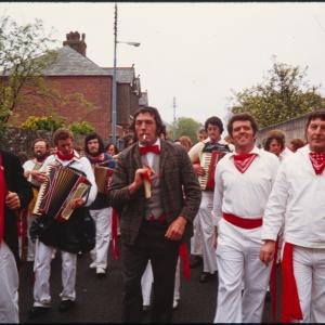 Old Oss band and master of ceremonies walking