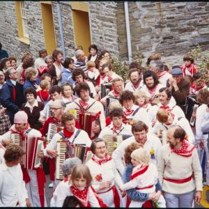 Old Oss accordion players walking in procession