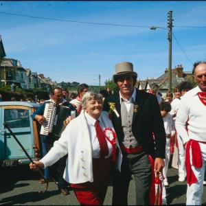Old Oss Master of Ceremonies with man and woman, accordion players behind