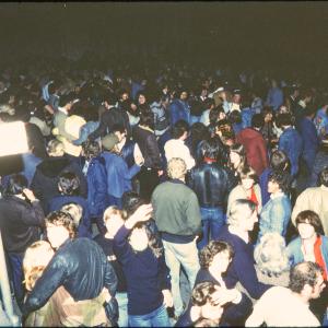 Crowd at night, person waving