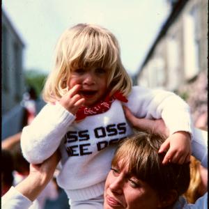 Child on woman's shoulders