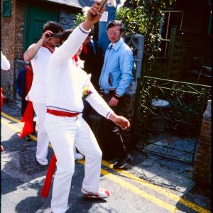 Man holding club up teasing Old Oss
