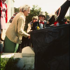 Old Oss greeting women at their house