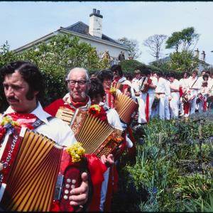 Old Oss band procession walking through garden