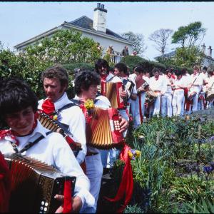 Old Oss band procession walking through garden