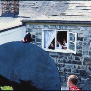 Children looking out through window at oss
