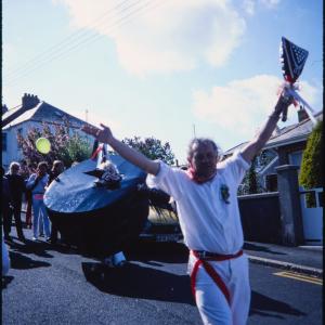 Man holding club up to sky