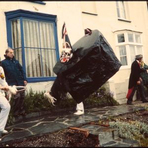 Old Oss dancing in someone's garden and Master of Ceremonies greeting women at their front door