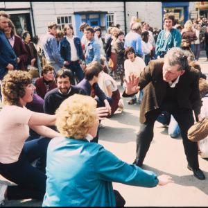 People sitting under maypole