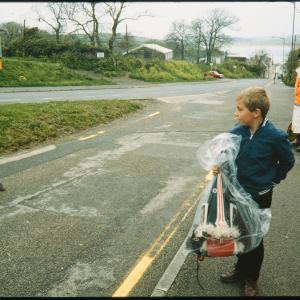 Boys on pavement with Oss hat in bag