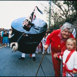 Woman posing with child in front of Old Oss on street