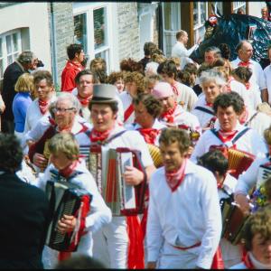 Old Oss accordion players walking in procession