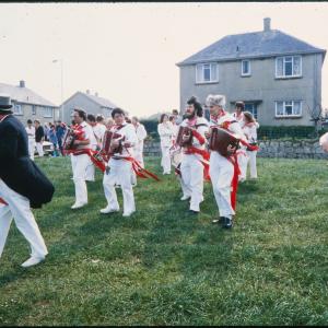 Old Oss band playing on green, led by Master of Ceremonies