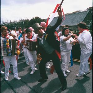 Master of Ceremonies dancing with women in procession