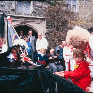 Child stroking Old Oss' mane in front of Prideaux Place house