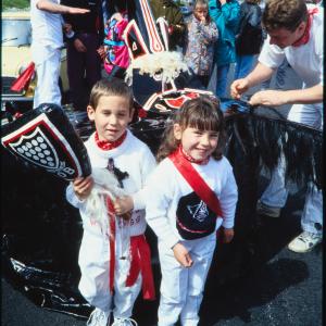 Children posing with club in front of Old Oss