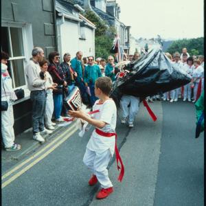Boy teasing Old Oss in road