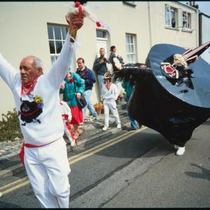 Teaser holding his hands in the air, in front of Old Oss