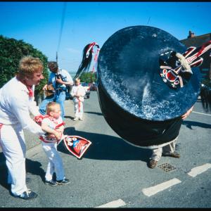 Old Oss being teased by child, helped by man