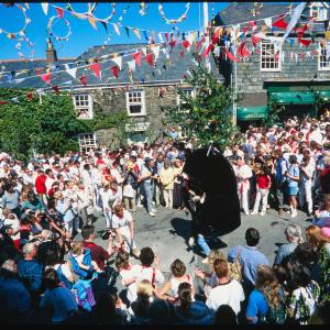 Old Oss being teased under Maypole in sun